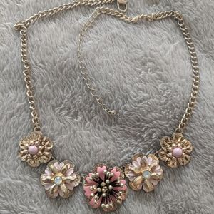 Gold floral necklace with pink accents